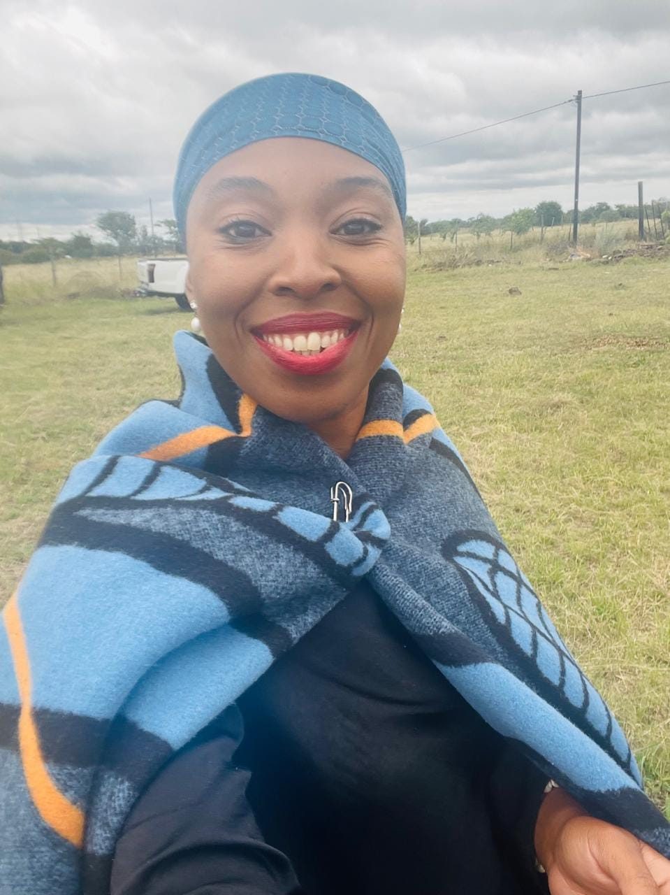 Lerato Senoko Dube wrapped in a traditional blanket, smiling warmly
