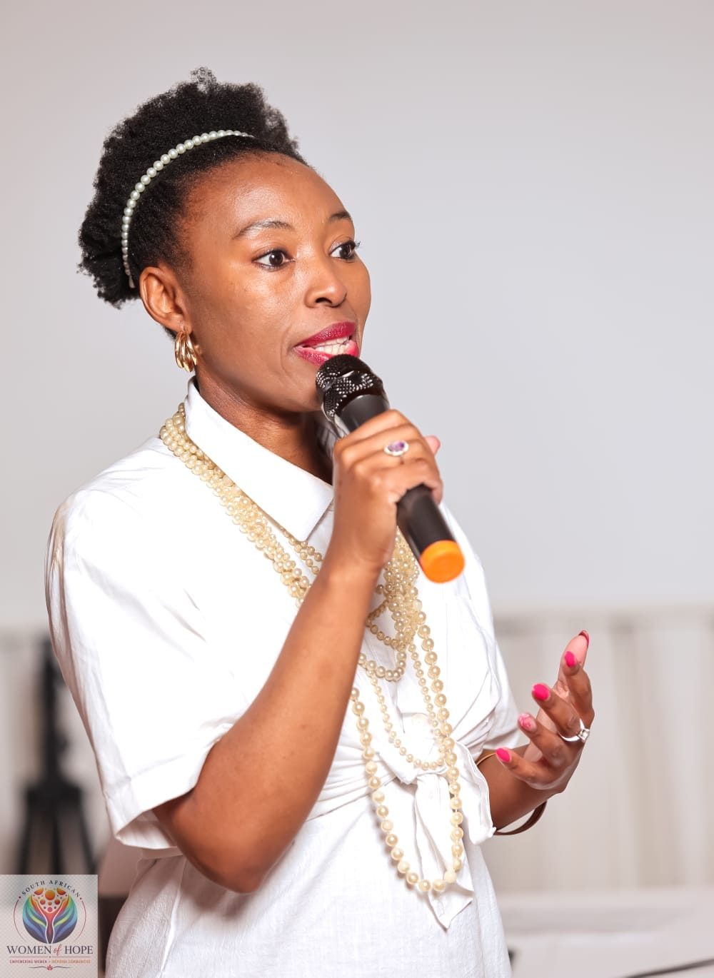 Lerato Senoko Dube speaking into a microphone at an event